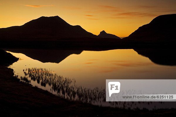 Sunset silhouette at Lochan an Ais  Inverpolly  Sutherland  north west Scotland  United Kingdom  Europe