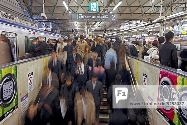 Commuters moving through Shibuya Station during rush hour  Shibuya District  Tokyo  Japan  Asia