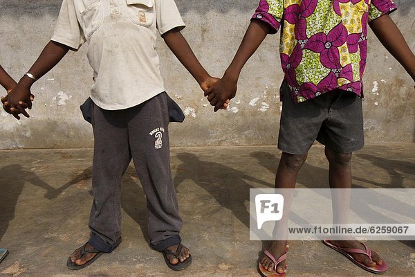 African schoolchildren holding hands  Lome  Togo  West Africa  Africa
