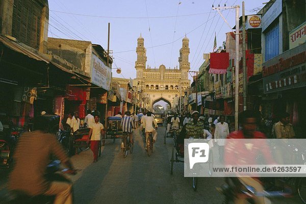 Street scene with bicycles and rickshaw and the Char Minar (Charminar) triumphal arch built in 1591  Hyderabad  Andhra Pradesh State  India