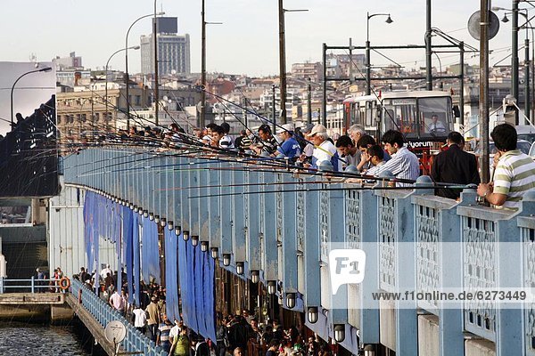 Fishermen standing on the Galata bridge  Istanbul  Turkey  Europe