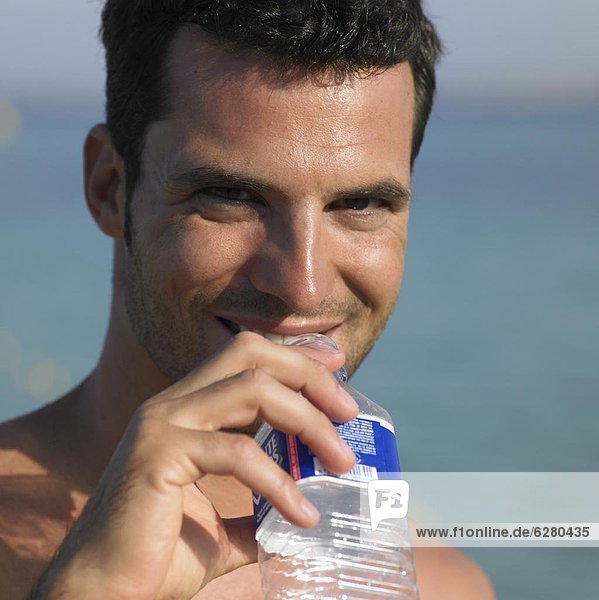 Man drinking from water bottle  close-up