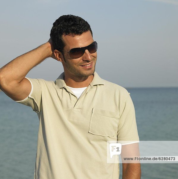 Man on beach wearing sunglasses