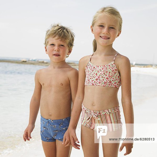 Boy and girl (6-8) on beach