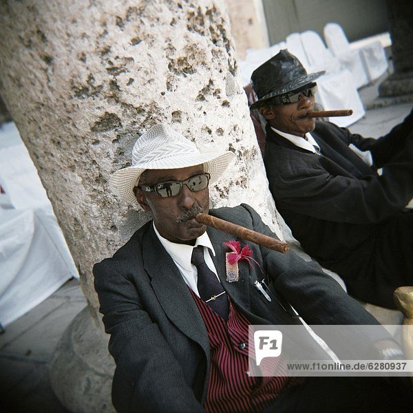 Elderly men posing with cigars  Havana  Cuba  West Indies  Central America