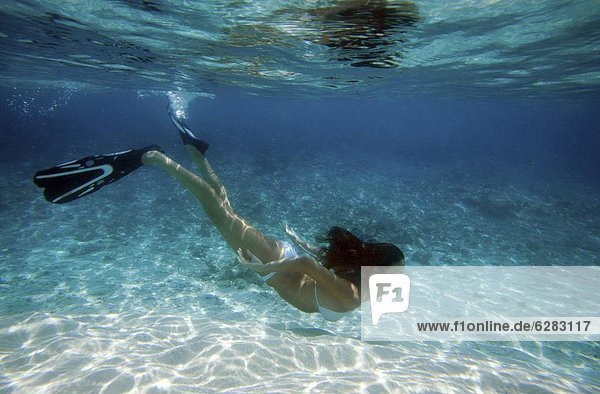 Girl snorkeling in The Maldives  Indian Ocean  Asia