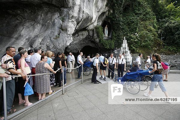 Pilgrims at the Lourdes grotto  Lourdes  Hautes Pyrenees  France  Europe