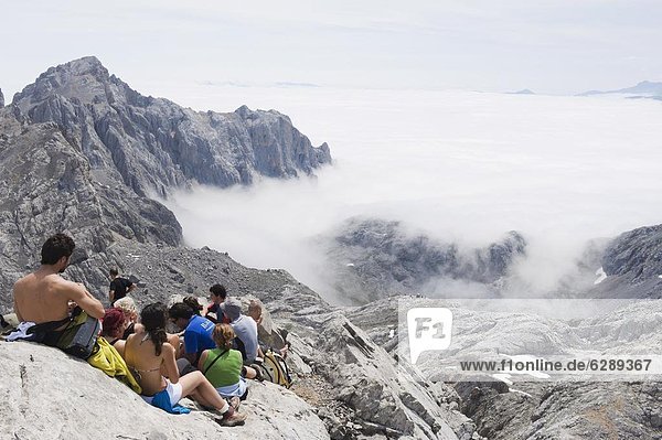 Hikers taking a break on Tesorero Peak  in Picos de Europa National Park  shared by the provinces of Asturias  Cantabria and Leon  Spain  Europe