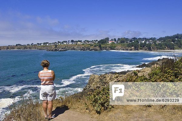 Woman on clif overlooking California's picturesque Mendocino coast  California  United States of America  North America