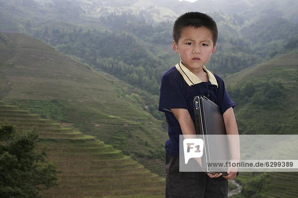 Boy of Yao mountain tribe minority with laptop  Longsheng terraced ricefields  Guangxi Province  China  Asia