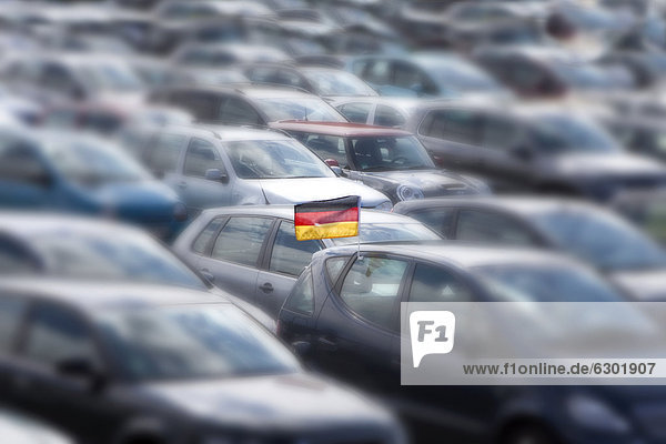 Car with a German national flag  occupied parking area  concept image for the lack of parking spaces in Germany