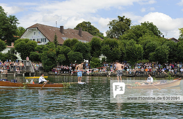 Traditional jousting event on the lake  Fischerstechen  in Ammerland  Muensing municipality  Lake Starnberg  Five Lakes region  Upper Bavaria  Bavaria  Germany  Europe