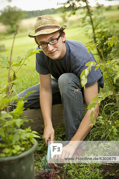 Junger Mann bei der Gartenarbeit
