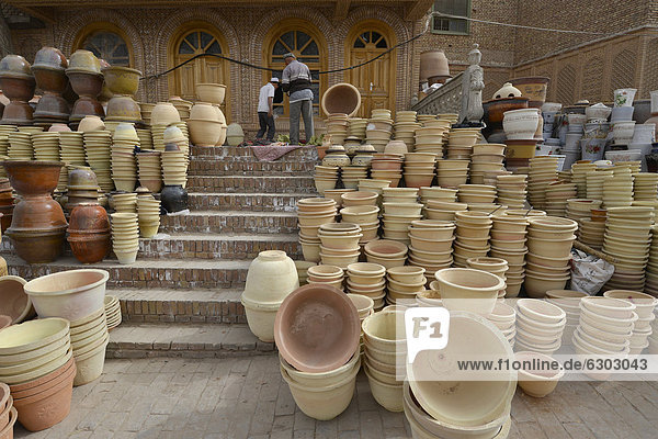 Kashgar crafts  Muslim Uighurs are offering their pottery and ceramics in front of an Uighur mud-brick house on the Kashgar craftsmen road  Silk Road  Xinjiang  China  Asia