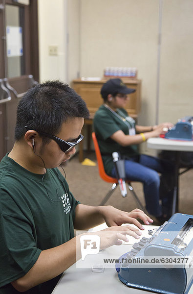 Blind students participate in the National Braille Challenge  a competition that tests their ability to transcribe  type  and read braille using a typewriter-like Perkins Brailler  annual event  sponsored by the Braille Institute of America  Los Angeles  California  USA. EDITORIAL USE ONLY.