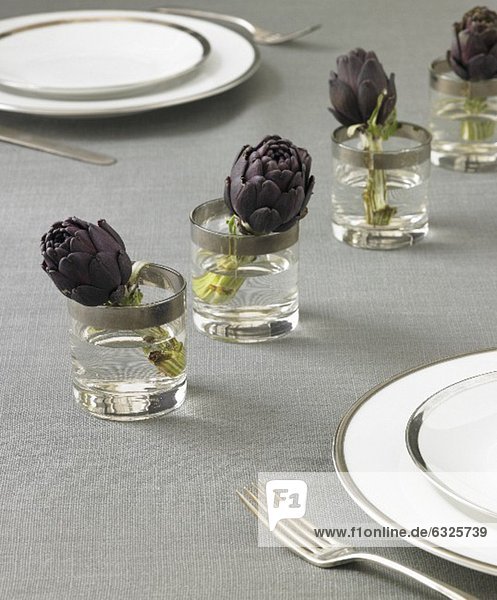 Table Setting with Artichokes in Glasses of Water
