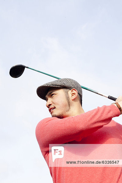 Portrait Of Golfer Swinging