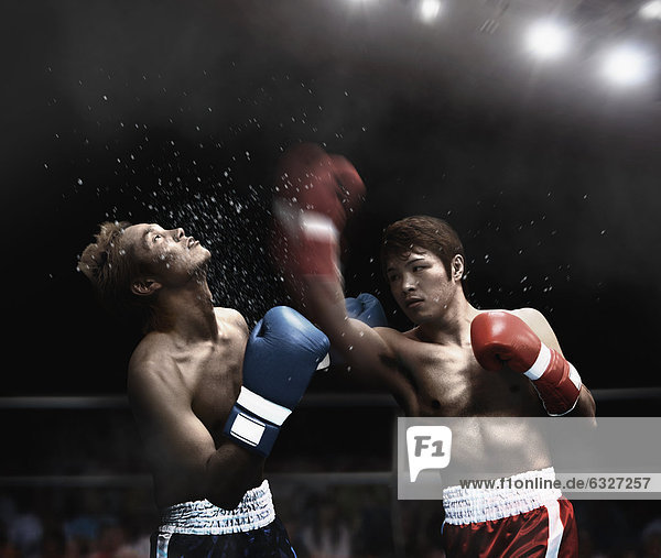 Boxers Fighting In Ring