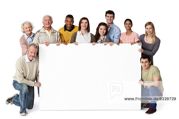 Group of people holding blank notice board