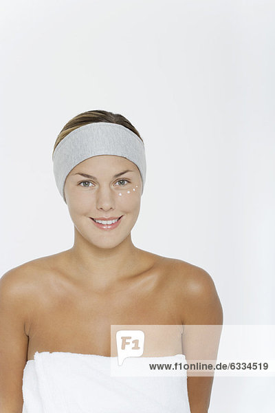 Young woman moisturizing skin