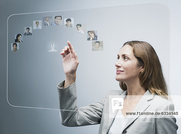 Human resources manager assessing candidates on advanced touch screen interface