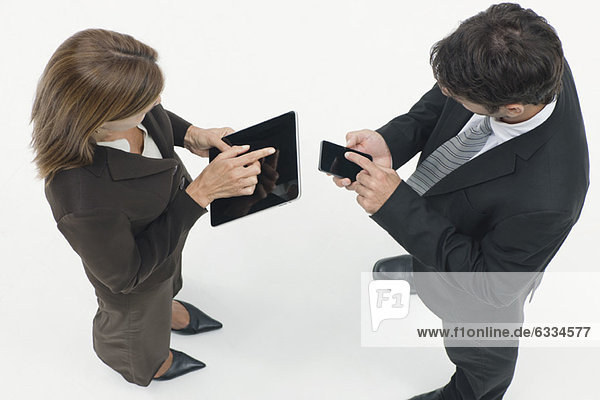 Business associates exchanging information with wireless devices