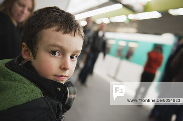 Boy waiting for train in subway station