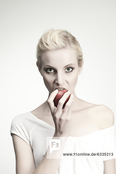 Young woman biting into apple  portrait