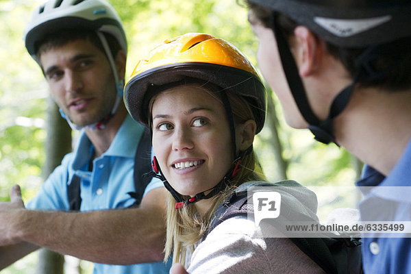 Cyclists hanging out together  focus on woman