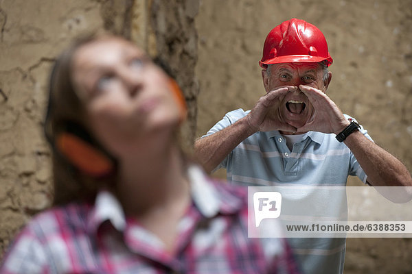 Construction worker yelling at colleague