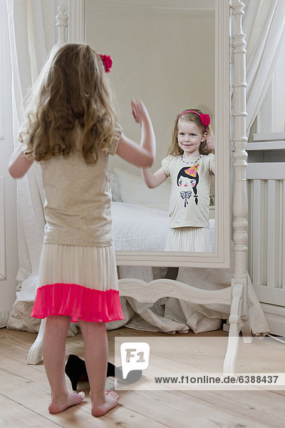 Girl admiring herself in mirror