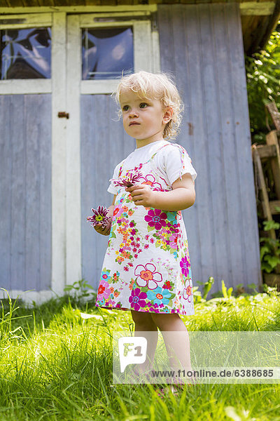 Girl picking flowers outdoors