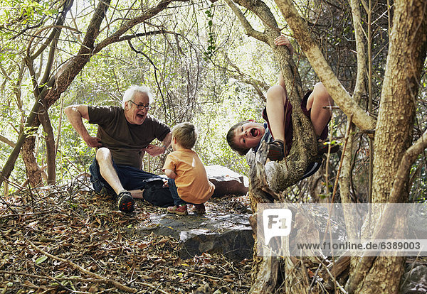 Father and his sons playing in the forest