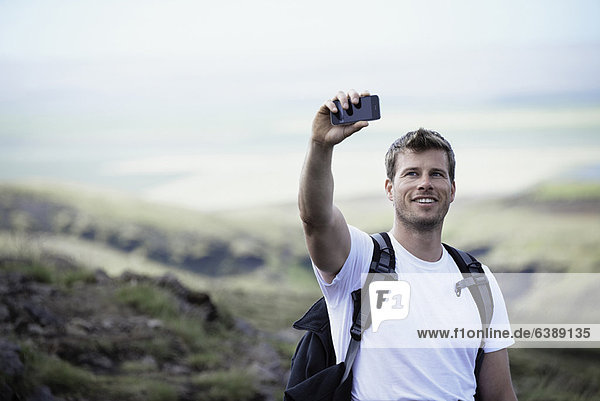 Hiker taking picture with cell phone