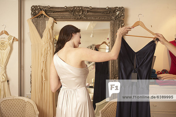 Woman trying on dress in store