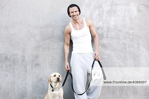 Caucasian man standing with dog
