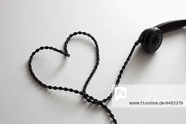 An old-fashioned telephone cord arranged into the shape of a heart