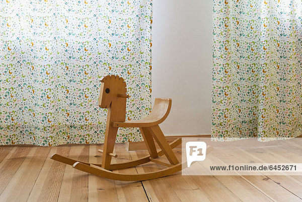 A rocking horse in a domestic room