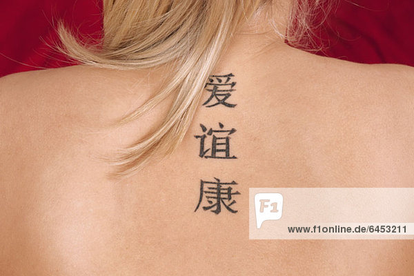 Eine Frau Tätowierungen von chinesischen Schriftzeichen Bedeutung Liebe  Freundschaft und Gesundheit