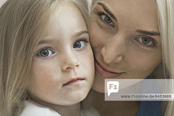 A beautiful young girl and her mother  close-up