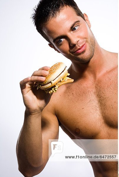 Bodybuilder mit Fast Food *** Local Caption ***