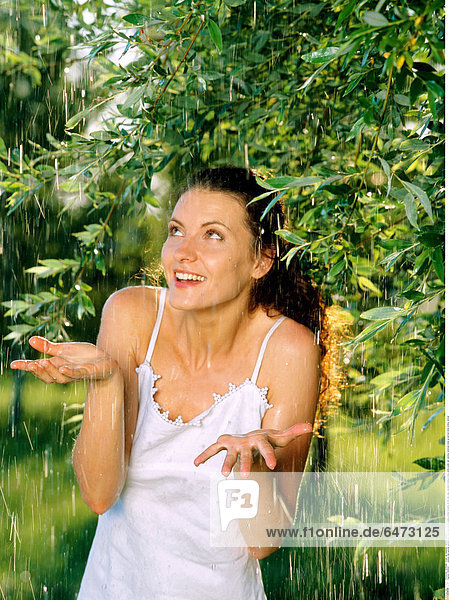 1222522 outdoor day summer garden park tree trees people young woman brunette 25-30 rest relax vacation holidays dress white water rain raindrop raindrops close up portrait smile smiling vertical
