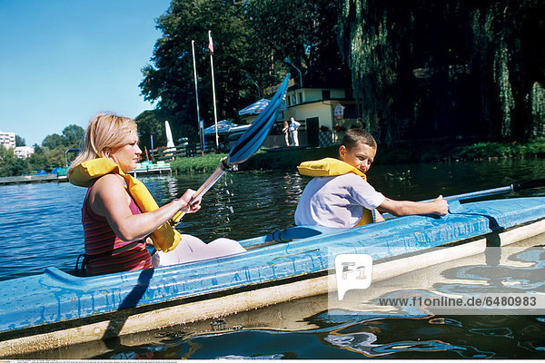 1228644 outdoor day summer people woman mother boy child 35-40 blonde dark haired hair 10-15 water lake river tree trees vacation recreation rest relax canoe oar oars life jacket smile smiling life jackets profile profiles horizontal