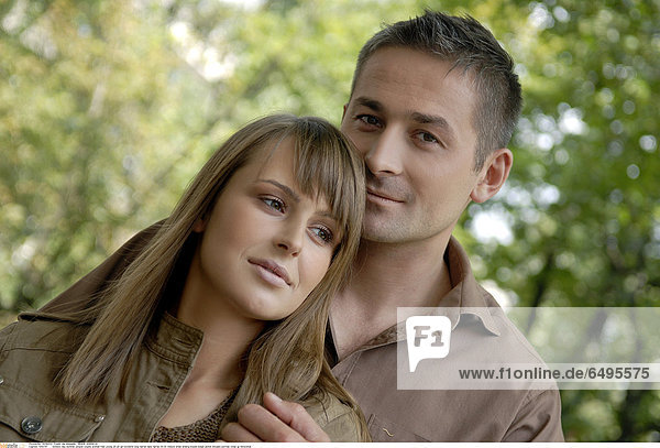 1243741 outdoor day summer people couple woman man young 20-25 girl brunette long haired dark haired 30-35 mature smile smiling blouse beige jacket blouses portrait close up horizontal