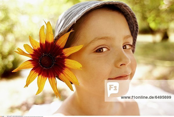 1243679 outdoor day summer park people child boy 5-10 rest relax close up portrait smile smiling cap blue sunflower horizontal