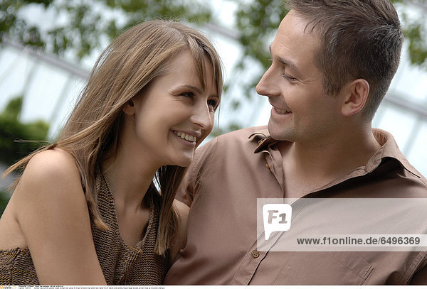 1243753 outdoor day summer people couple woman man young 20-25 girl brunette long haired dark haired 30-35 mature smile smiling blouse beige blouses portrait close up horizontal embrace
