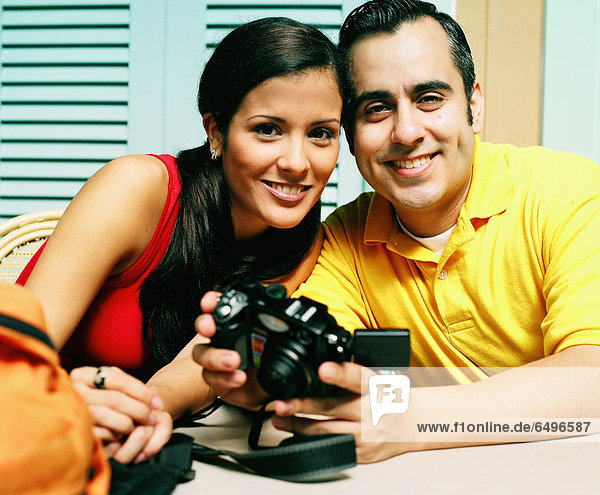 Young couple smiling with camera