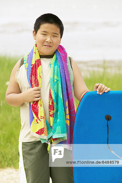 Portrait of boy with body board