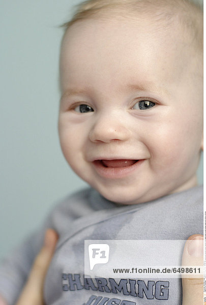 STC_0000648 indoor flat people baby 0-5 boy fair haired grey blouse woman fragment hand hands take up smile smiling mother son close up vertical