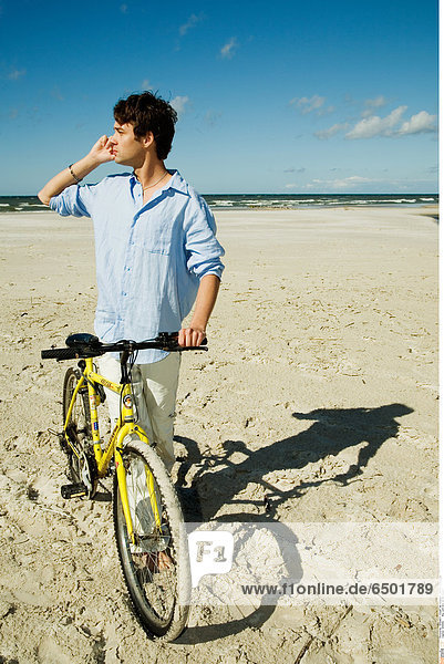 1256992 Boy with bike on the beach